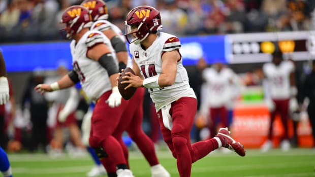 Dec 17, 2023; Inglewood, California, USA; Washington Commanders quarterback Sam Howell (14) moves out to pass against the against the Los Angeles Rams during the first half at SoFi Stadium.